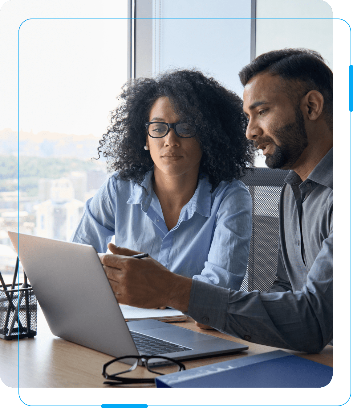 A man and woman looking at a laptop